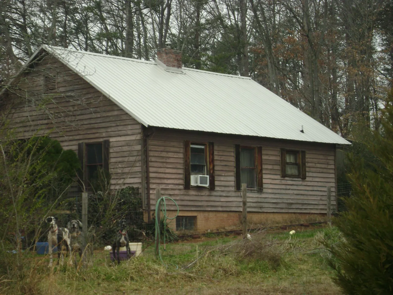 White metal roof on an old wood sided farmhouse, from a Metal Roof Installation job in Kearney